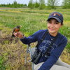 Abbigail Turner holding a bird in a field